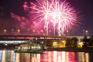 Firework over Moscow —  Moskva River, Luzhnetskaya Bridge (Metro Bridge) in the light of night colored lights. Moscow, Russia